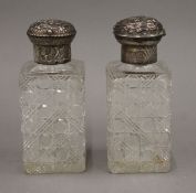 A pair of silver topped hobnail cut glass square bottles, London 1884. 15 cm high.