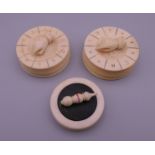 Three Victorian ivory gaming pieces. The largest 4.5 cm diameter.