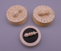Three Victorian ivory gaming pieces. The largest 4.5 cm diameter.