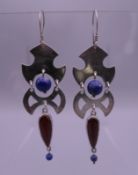 A handmade pair of earrings by Sue Lowday, circa 1992. 6 cm high.