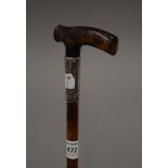 A walking stick with a tortoiseshell handle. 90 cm long.