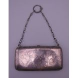 A silver purse. 11 cm wide.