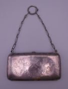 A silver purse. 11 cm wide.