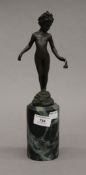 A bronze model of a young girl mounted on a marble plinth base. 32 cm high.