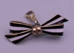 An enamel bow brooch. 4.25 cm wide.