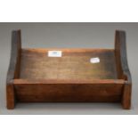 A late 19th/early 20th century carved book trough. 30.5 cm wide.