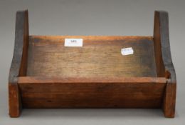 A late 19th/early 20th century carved book trough. 30.5 cm wide.