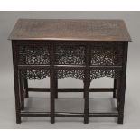 A profusely carved Anglo-Indian coffee table. 76 cm long.