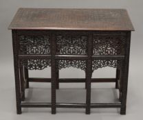A profusely carved Anglo-Indian coffee table. 76 cm long.