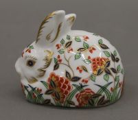 A Royal Crown Derby porcelain paperweight, Meadow Rabbit, with gold stopper. 7 cm high.