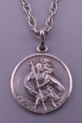 A silver St. Christopher pendant on a silver chain. The pendant 2.75 cm high.