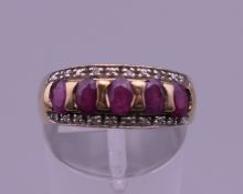 A 9 ct gold diamond and ruby ring. Ring size M/N. 2.5 grammes total weight.