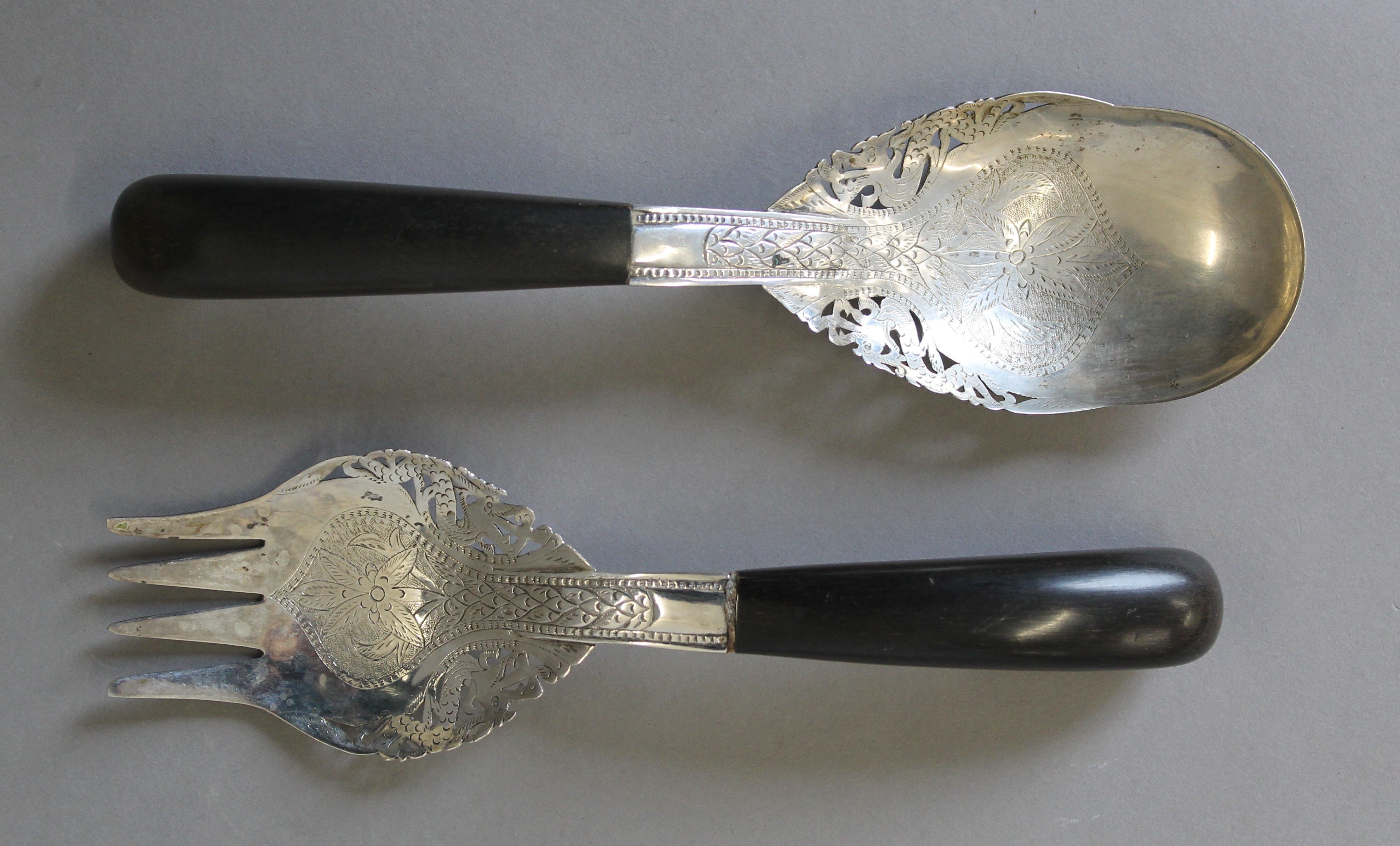 A pair of Eastern unmarked white metal salad servers with horn handles. The spoon 24 cm long.