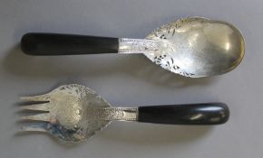 A pair of Eastern unmarked white metal salad servers with horn handles. The spoon 24 cm long.