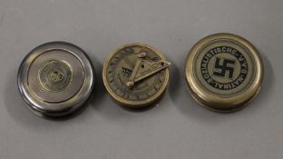 Three brass compasses.