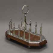A Victorian silver plated and oak toast rack. 18.5 cm long.