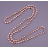 A pearl necklace. 110 cm long.