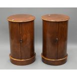 A pair of walnut cylindrical bedside cupboards. 72 cm high x 43 cm diameter.