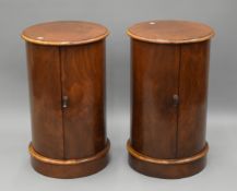 A pair of walnut cylindrical bedside cupboards. 72 cm high x 43 cm diameter.