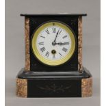 A slate and marble mantle clock. 20 cm high.