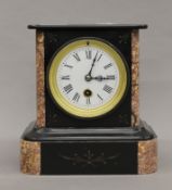 A slate and marble mantle clock. 20 cm high.