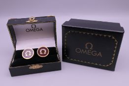 A pair of modern Omega cufflinks, boxed.