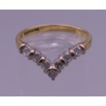 An 18 ct gold diamond wishbone ring. Ring size N/O. 2.9 grammes total weight.