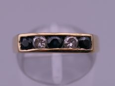 A 9 ct gold diamond and sapphire ring. Ring size N. 2.9 grammes total weight.