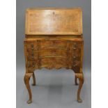 An early 20th century Queen Anne style walnut bureau. 61 cm wide.