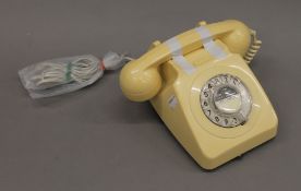 A cream coloured vintage telephone.