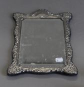 A silver framed mirror. 37 cm high.