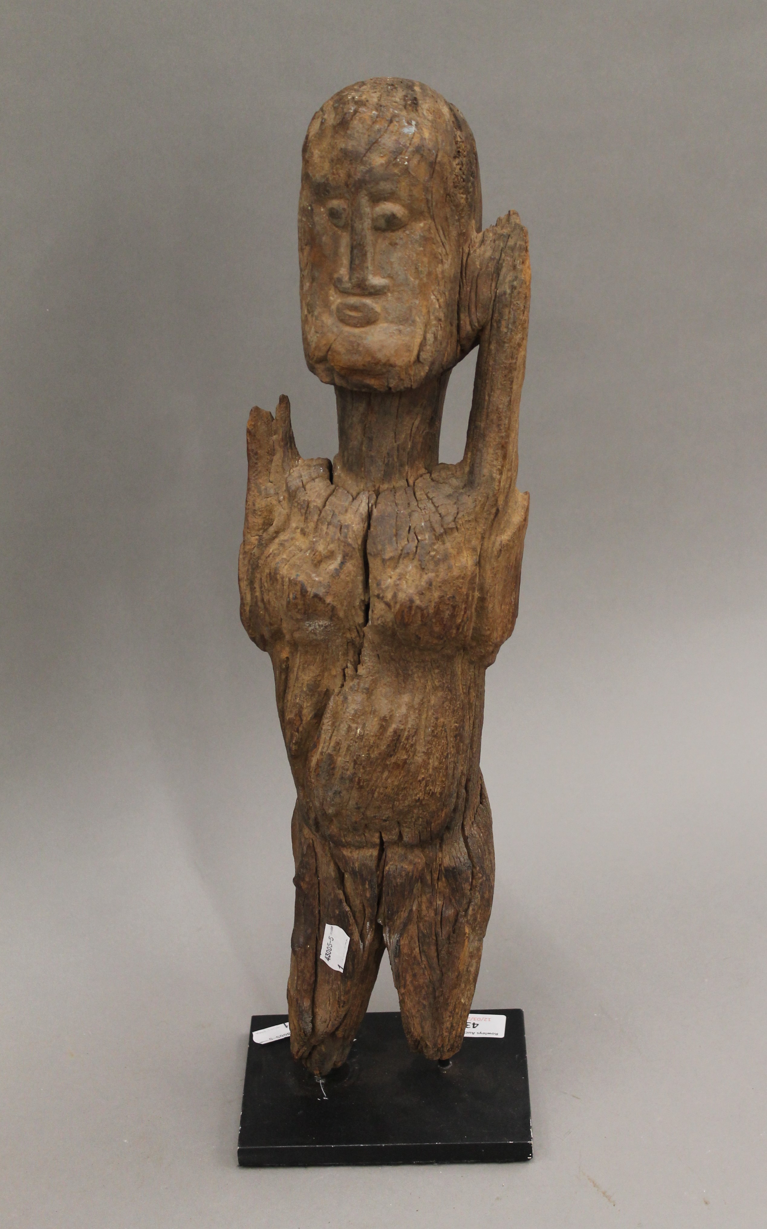 An African figural carving mounted on a later display plinth. 55 cm high.