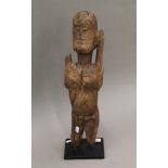 An African figural carving mounted on a later display plinth. 55 cm high.