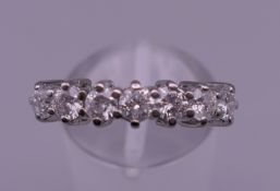 An 18 ct gold 1 carat seven stone diamond eternity stacking ring. Ring size P. 3.