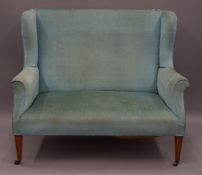 An Edwardian upholstered two seated settee. 120 cm wide.