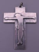 A Jean Despres unmarked white metal cross form pendant. 7 cm high.