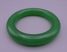 An apple green jade bangle. 5.75 cm inner diameter.