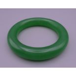 An apple green jade bangle. 5.75 cm inner diameter.