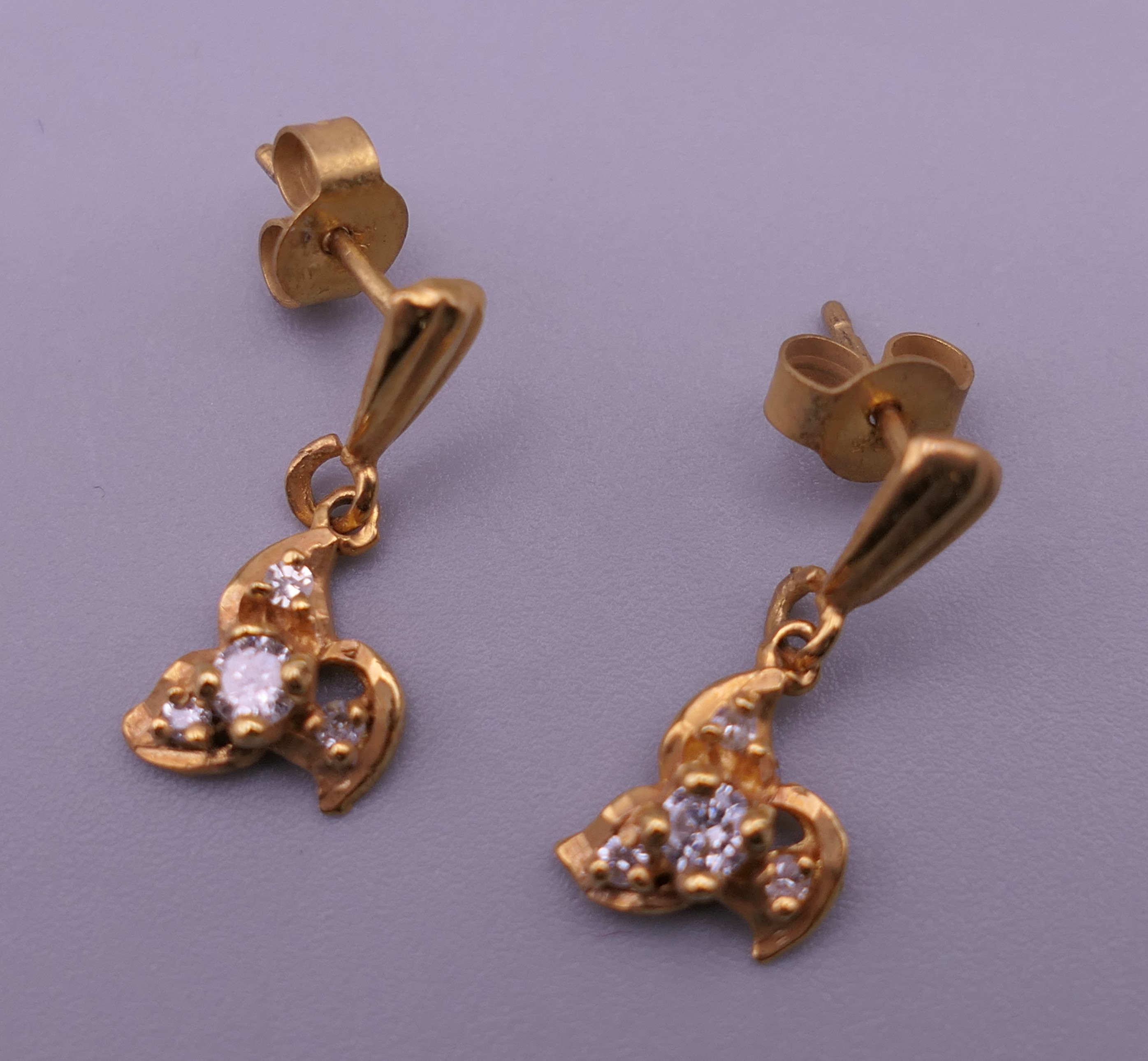 A pair of gold diamond set earrings. 1 cm high. 1.4 grammes total weight. - Image 3 of 5
