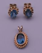 A pair of 9 ct gold blue stone, possibly tanzanite, earrings and a matching pendant. 1.