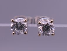 A pair of 18 ct white gold solitaire diamond earrings. 4 mm wide.