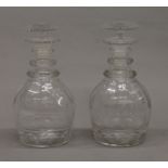 A pair of 19th century ring neck decanters. 22.5 cm high.