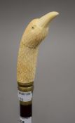 A walking stick with a carved bone handle formed as a bird. 89.5 cm long.