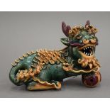 A Chinese pottery dog-of-fo. 16 cm long.