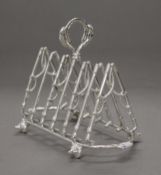 A silver plated toast rack formed as riding crops. 20.5 cm long.