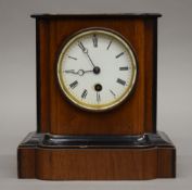 A Victorian walnut mantle clock. 20 cm high.