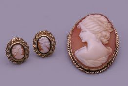 A pair of 9 ct gold cameo earrings and a 9 ct gold cameo brooch/pendant. The latter 3.25 cm high.