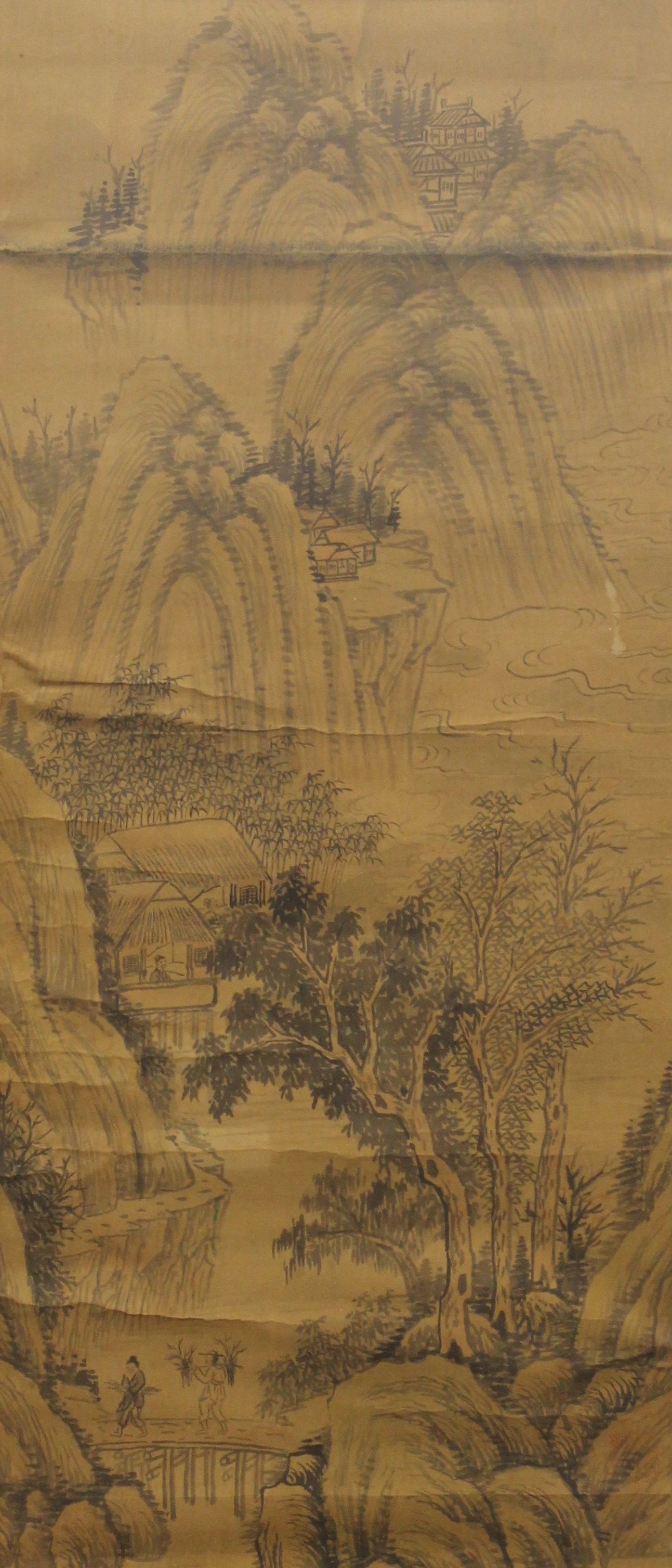 A 19th century Chinese silk scroll depicting Figures in a Mountainous Landscape, framed and glazed.