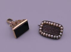 An early 19th century mourning brooch and a 9 ct gold seal. The latter 2.5 cm high and 4.