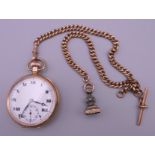 A 9 ct gold cased open faced top wind pocket watch and a 9 ct gold Albert chain. 121.5 grammes.